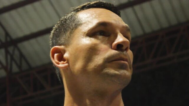 Portrait of a Hispanic athlete focused before a soccer match on a night field in Neiva, Huila, Colombia. Concept of sports and emotions