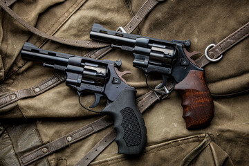 Pair of classic black revolvers on canvas back