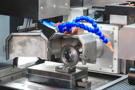 Modern industrial automatic abrasive disc grinder tool sharpening machine close-up, industrial concept - Powered by Adobe