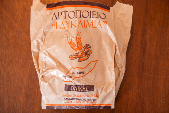 Karkinagri, Greece - June 1, 2023: White bread whole loaf from Ikaria longevity blue zone food label from Ikarian Raches bakery macro closeup