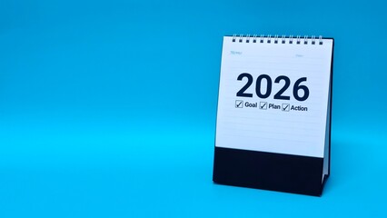 Calendar page of 2026, on blue background with copy space and business design. Concepts of planning for success, setting goals, planning strategies and taking action steps.