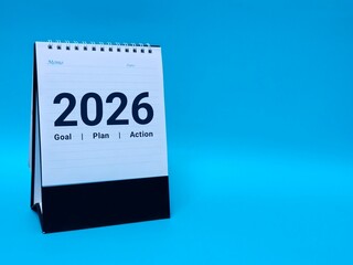 Calendar page of 2026, on blue background with copy space and business design. Concepts of planning for success, setting goals, planning strategies and taking action steps.