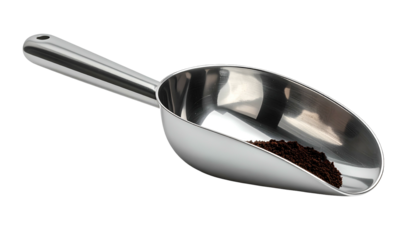 A shiny stainless steel scoop holds ground coffee, isolated against a black background