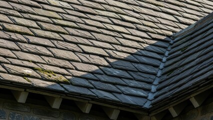 Close-up of a weathered slate roof with intricate patterns and textures.
