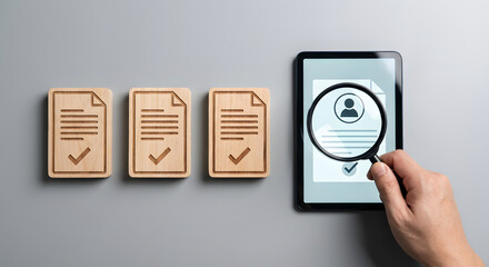 magnifying glass on tablet with documents, background check concept