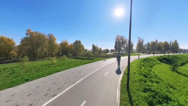 A Caucasian man rollerblades quickly.