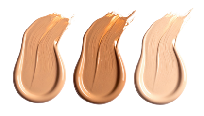 Swatches of skin-tone foundation in varying shades, against a black background