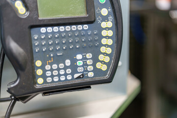 Control panel used in manufacturing process for machinery adjustments and settings in a workshop environment