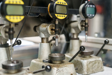 Machinery in a workshop showing devices for measuring and testing materials during industrial processes