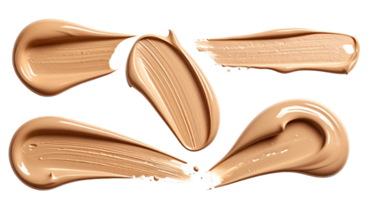 Swatches of light-toned liquid makeup on a black background, showcasing texture