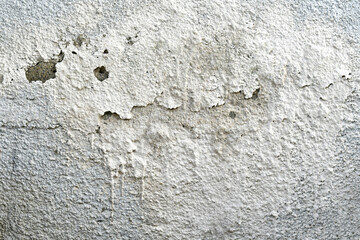 Dirty old cracked peeling broken concrete wall texture background. Uneven distress wall. Grunge and rough surface.