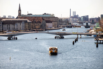 Water Bus (yellow ferry) sailing on canal on the outskirts of Copenhagen, Denmark
