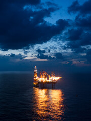 Offshore jack up rig in aerial view in the middle of the ocean taken by a drone
