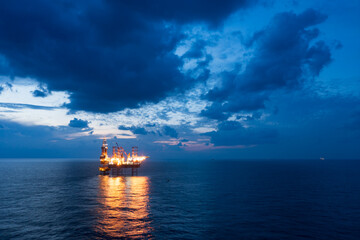 Offshore jack up rig in aerial view in the middle of the ocean taken by a drone