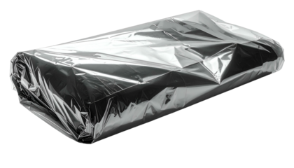 A rectangular object, wrapped tightly in transparent, crinkled plastic, sitting on black