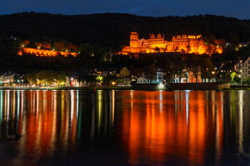 Historic Heidelberg Castle over Neckar River at Night.Heidelberg castle reflected in the Neckar River at night. Heidelberg, Germany.
