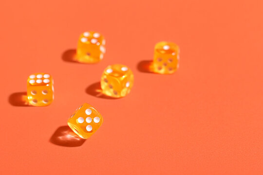 Orange game dices on color background