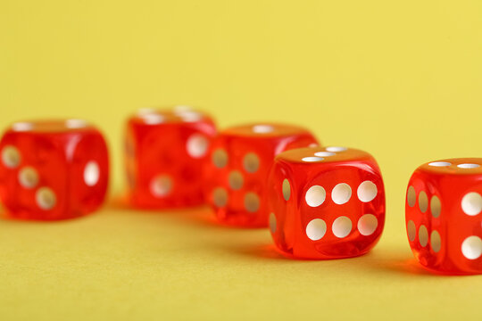 Red game dices on yellow background