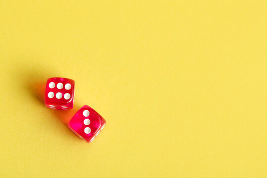 Red game dices on yellow background