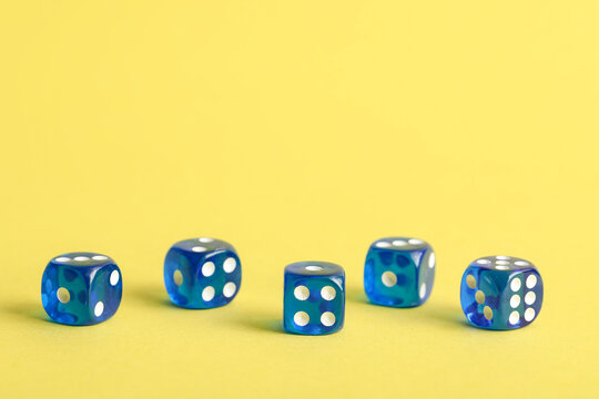 Blue game dices on yellow background