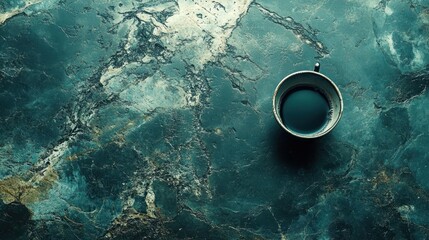 Dark coffee cup on teal marble surface