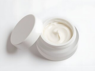Open jar of white cream on plain background for skincare
