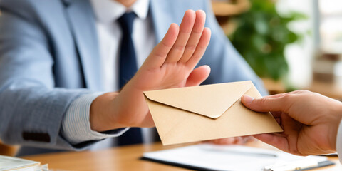 A businessman refuses a bribe and makes a "stop" gesture. The concept of honesty in business.