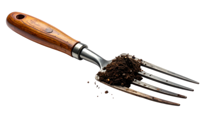 Close-up of a garden hand fork, tines filled with dark, rich soil, wooden handle