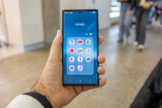 Porto, portugal; 12 28 2025 hand holding smartphone displaying google apps and android interface