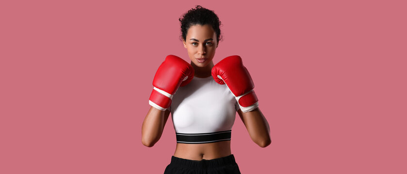 Female African-American boxer on pink background - Powered by Adobe