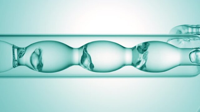Large vertical close-up of air bubbles rising irregularly through luminous clear liquid while it drains from a bulb laboratory condenser on cyan ramp background | Lotion product commercial concept