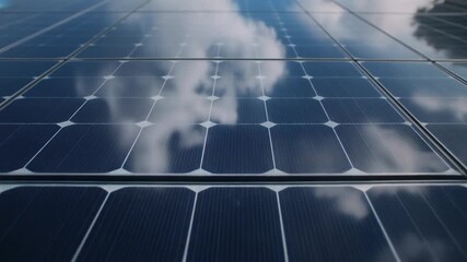 Close-up view of solar panels reflecting the sky and clouds, showcasing renewable energy technology. - Powered by Adobe