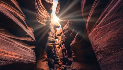 Sunlight shining through a narrow canyon with red rock formations.