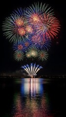 Fototapeta premium Spectacular Fireworks Display Illuminating Night Sky over Tranquil Water