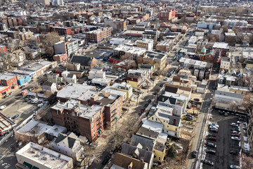 Aerial drone views looking straight down over Jersey City streets reveal dense urban patterns, intersecting roads, rooftops, and city blocks, showcasing the scale, layout, and everyday rhythm of a mod