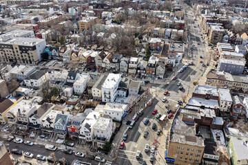 Aerial drone views looking straight down over Jersey City streets reveal dense urban patterns, intersecting roads, rooftops, and city blocks, showcasing the scale, layout, and everyday rhythm 