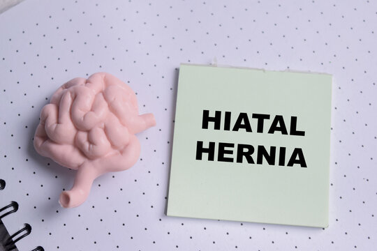 Concept of hiatal hernia write on sticky notes isolated on Wooden Table.
