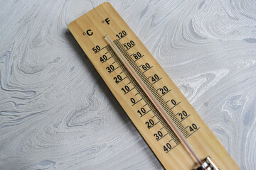 An analog thermometer on table background. symbolizing measurement and environmental control