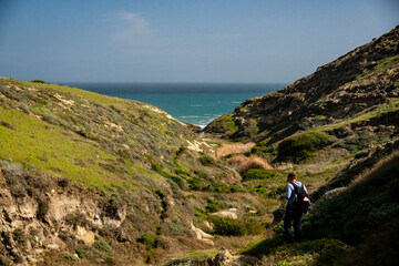 Fototapeta premium Hiker Heading Down To The Beach In Lobo Canyon On Santa Rosa Island
