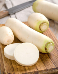 Japanese Daikon Radish Sliced on Rustic Wood Board
