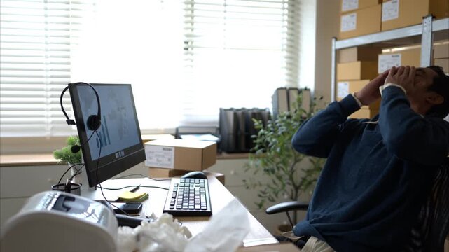 Label printer malfunction on work desk while stressed warehouse owner faces business problems and operational failure in storage office