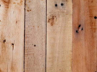 Natural wooden plank texture with smooth surface arranged vertically, featuring knots, nails, and color variations, suitable for wall, pallet, or rustic background use.