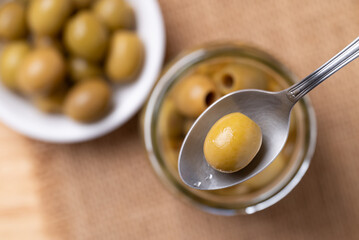Pickled olives, Pitted green olives in spoon, Top view