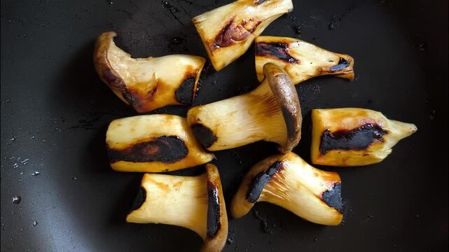 Grilling oyster mushrooms in pan, indoor Chiangmai Thailand.
