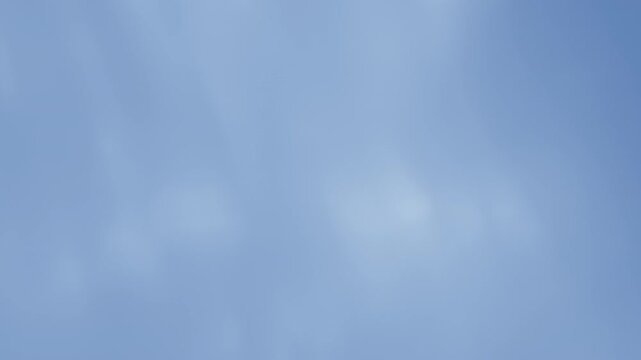 Cool-toned shimmering light leak overlay, opacity fades in and out, suitable for video transitions or blending effects