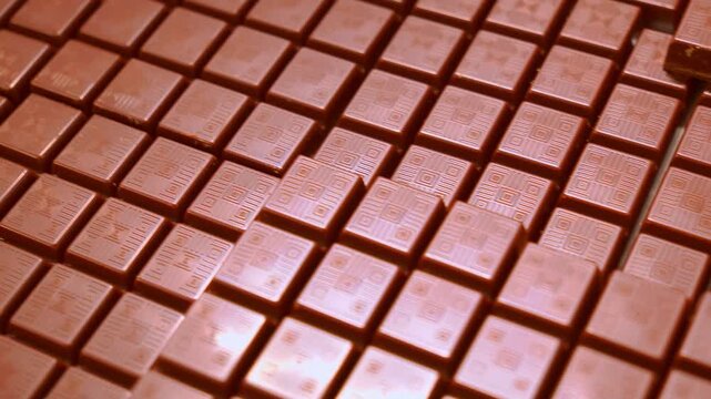 Smooth aerial glide over endless chocolate bars. Rich textured surface in 4K.