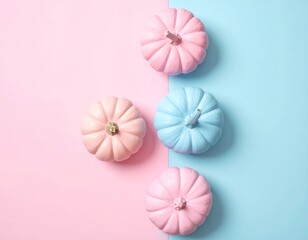 Pastel pumpkins on divided pink/blue. Flatlay, soft light