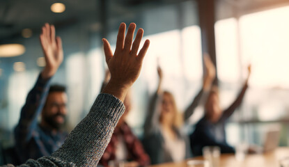Business team members raising hands in an enthusiastic meeting, demonstrating engagement and participation in a modern office environment