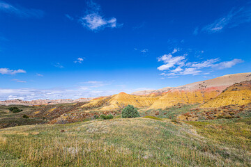 Fototapeta premium Beautiful landscape at Badlands National Park on a sunny with clouds autumn day.