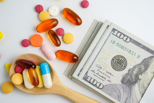 Medicine prescription drugs cost concept, Pills on money dollars, healthcare expenses